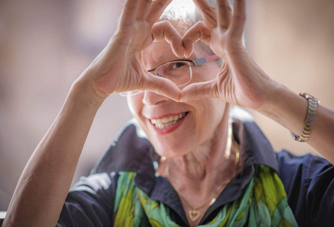 A lady showing love sign with hands